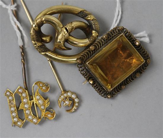A Victorian yellow metal openwork brooch, a similar citrine brooch and two pearl set yellow metal stick pins.
